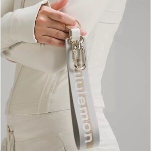 Lululemon Never Lost Keychain Wordmark Vapor and Gold